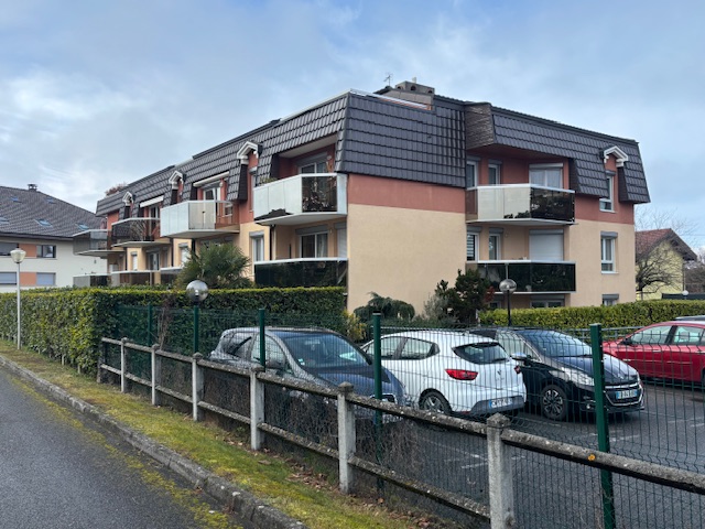 Résidence avec balcons et voitures garées